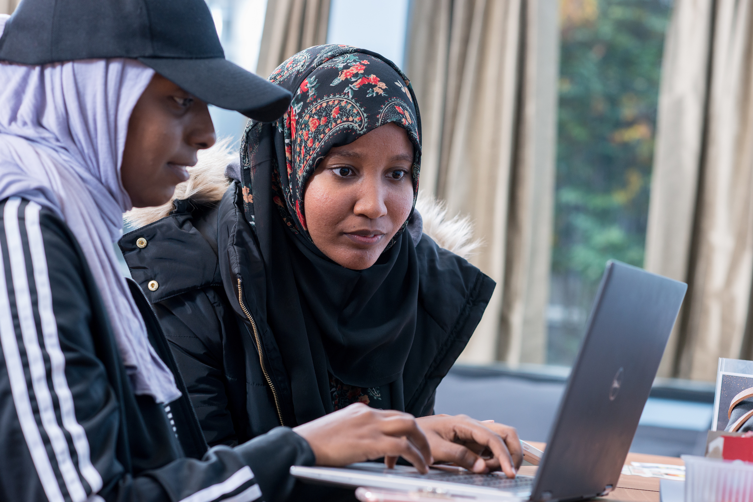 Two students looking at laptop