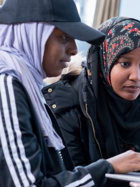 Two students looking at laptop