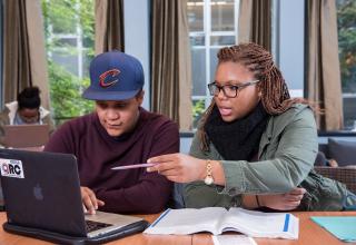 Two students looking at laptop