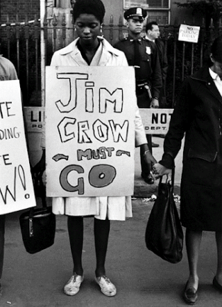 Protesters with sign, "Jim Crow Must Go"