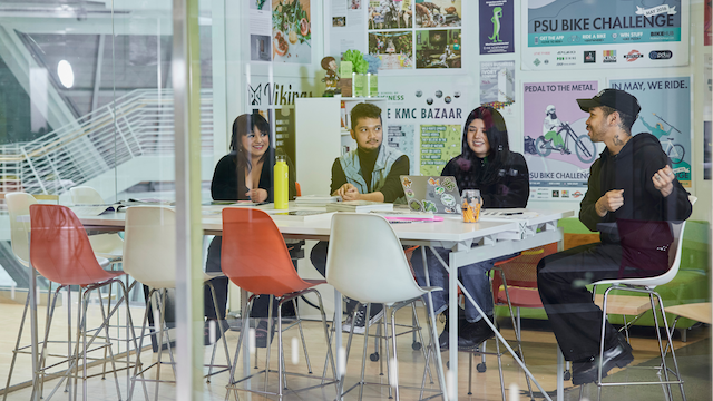 Student working together around a table.