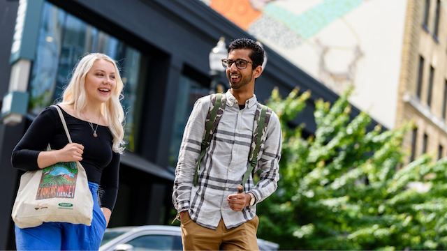 Students walking and talking in park blocks. 
