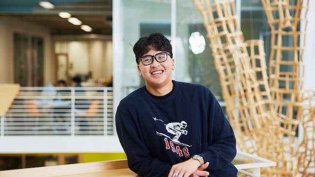 Student smiling on third floor of KMC.