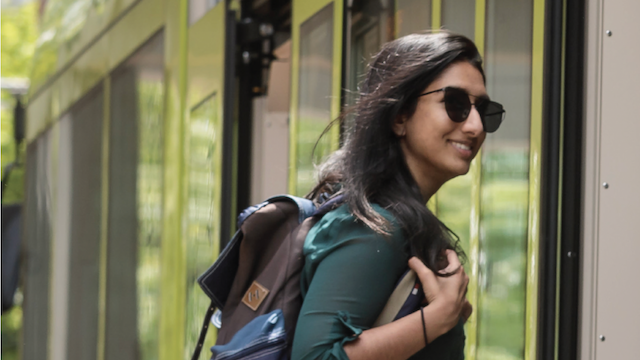 Student walking onto street car.