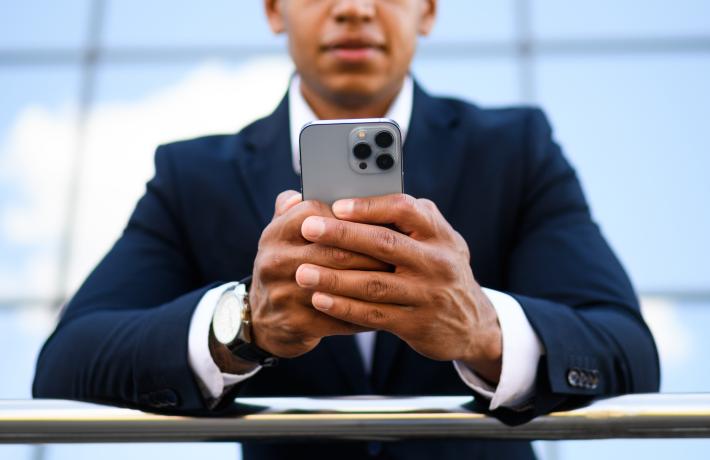 man in suit looking at phone