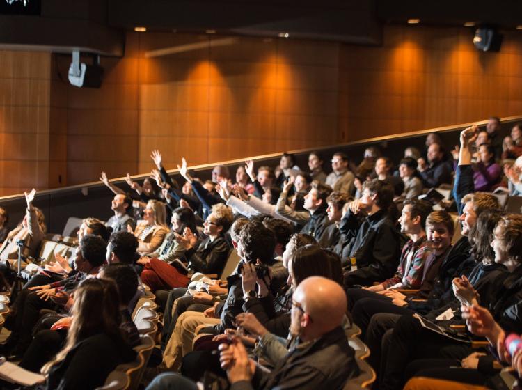 2019 Elevating Impact Summit Audience Raising Hands.