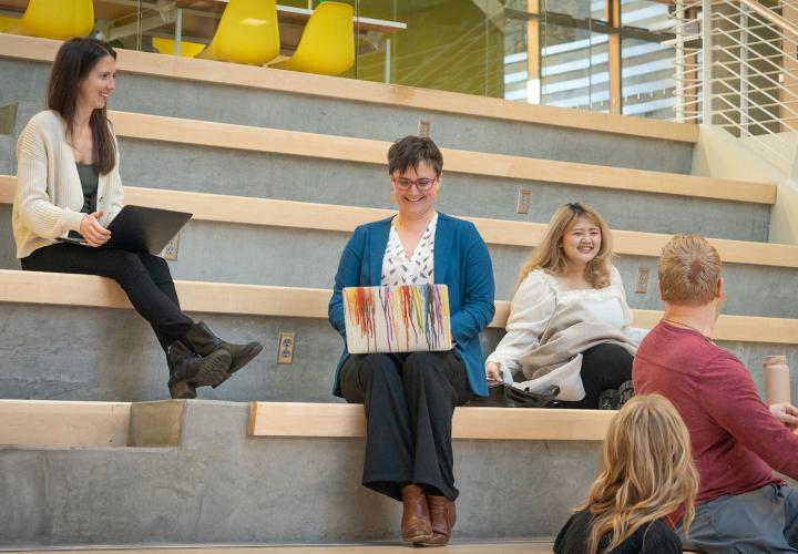 Students studying on atrium steps
