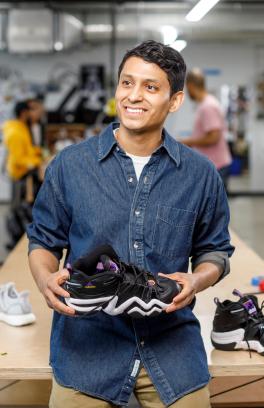 Edwin Martinez holding athletic shoe
