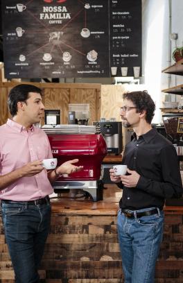 Two people talking at Nossa Familia Coffee 