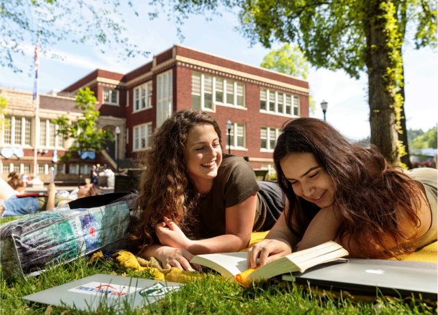 Two students studying in the park blocks, enjoying open space offered on the PSU campus