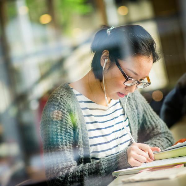 student working in library on campus