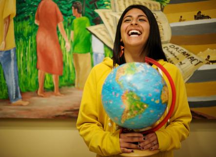student holding globe