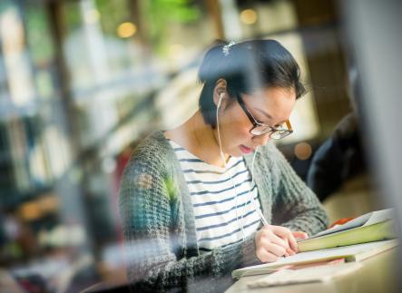student working in library on campus
