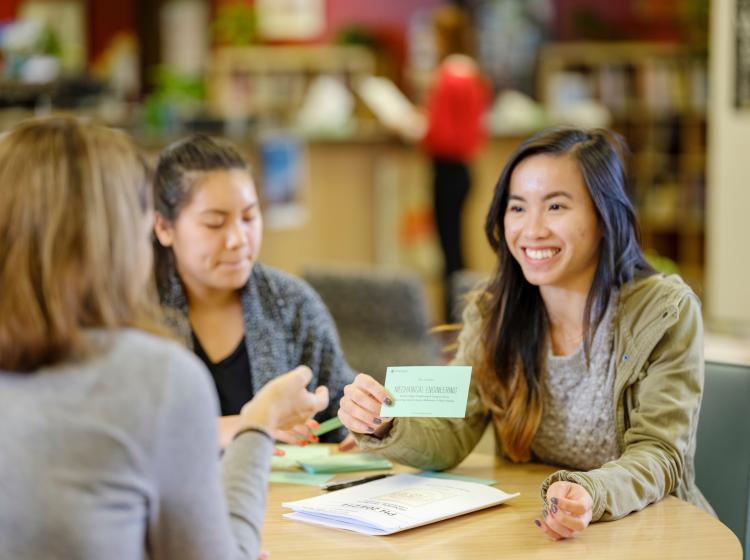 two students engaging in career exploration activity with career counselor 