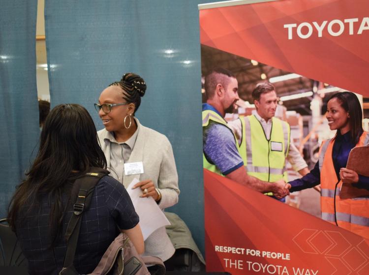 Recruiter from Toyota talking with 3 students