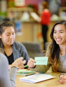 two students engaging in career exploration activity with career counselor 