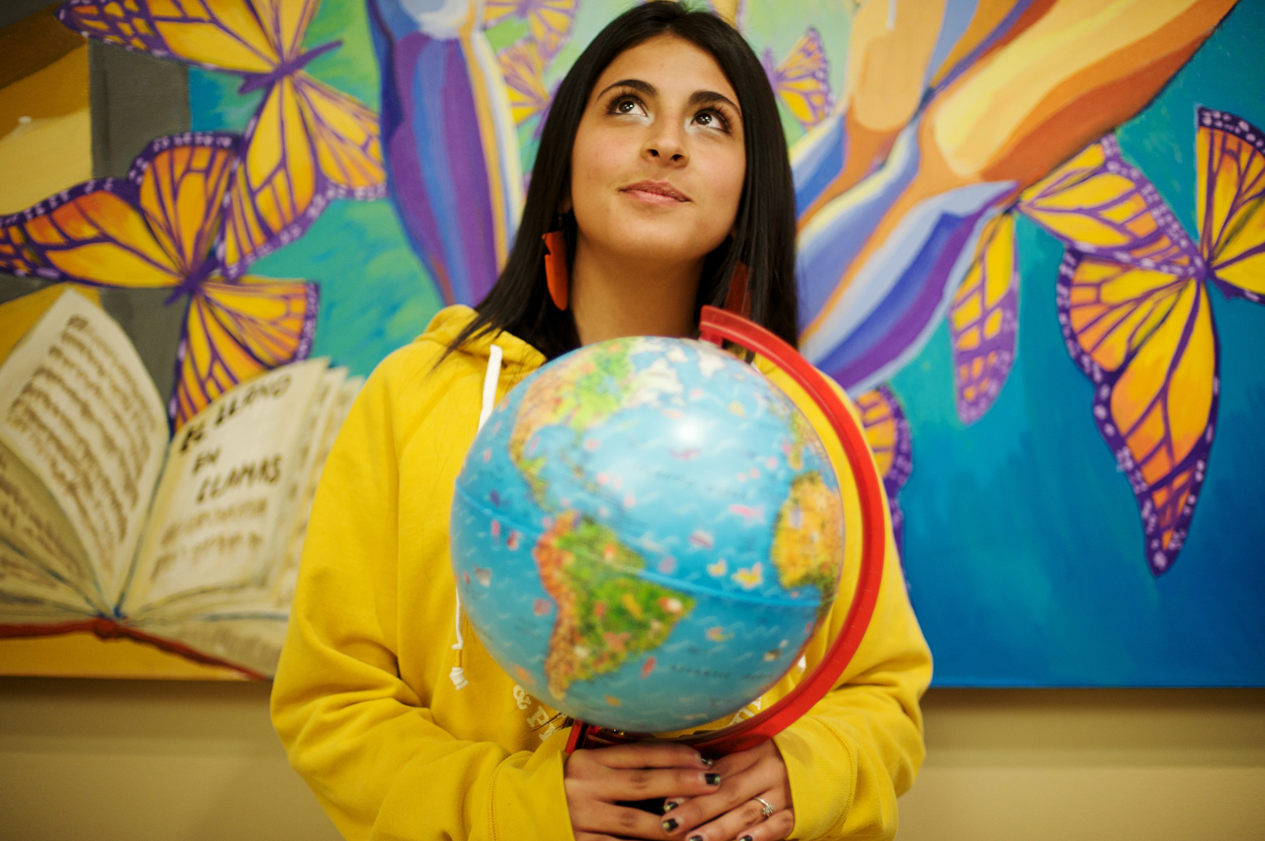 Student holding globe