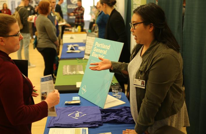 A student presenting their work at an event.
