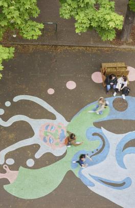 Group of people walking across a PSU mural