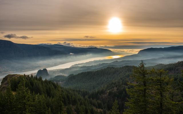 columbia river with the sun setting in the back