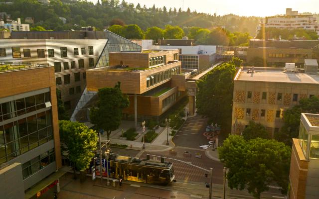 the Karl Miller Center campus with a light rail passing by