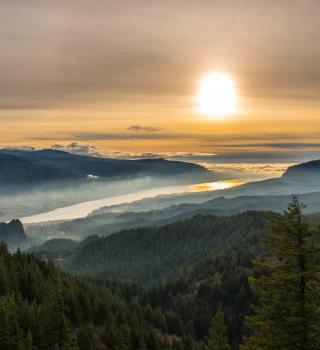 columbia river with the sun setting in the back