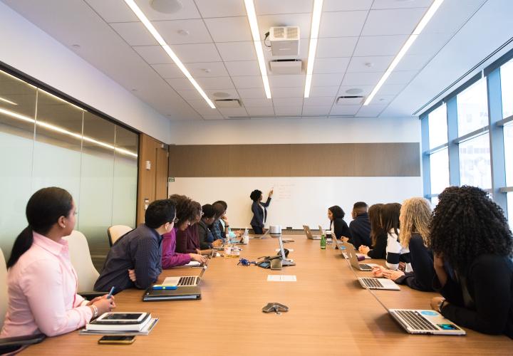 group of people in a conference looking at the speaker
