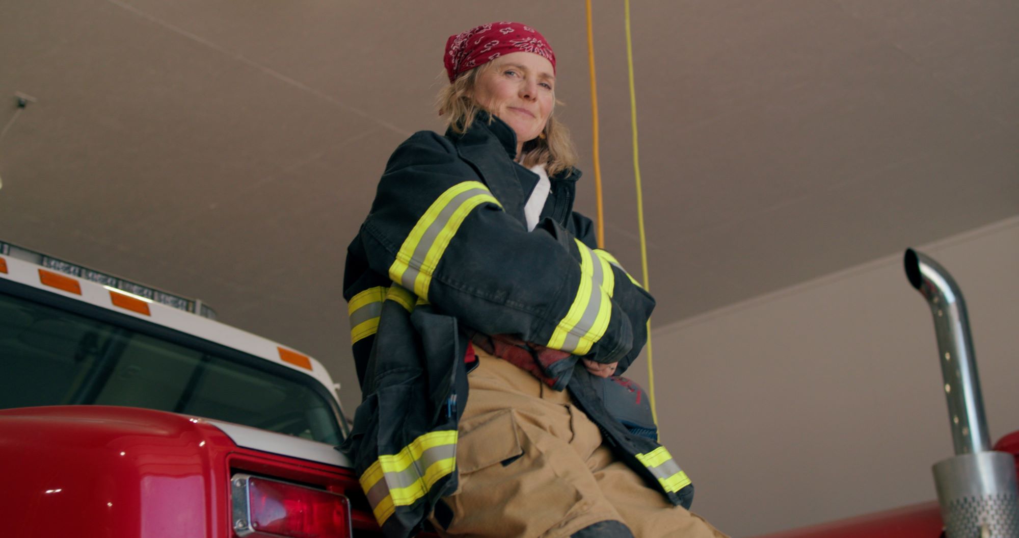 Turn Up Your Voice Rural Cohort Member, Debi learning against firetruck