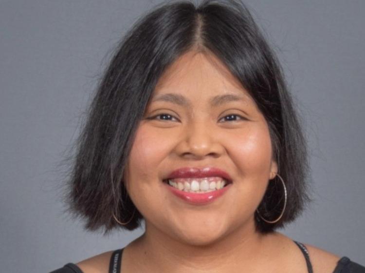 Photo of woman smiling into camera wearing a black tshirt