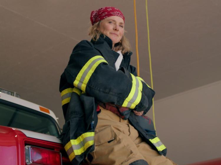 Turn Up Your Voice Rural Cohort Member, Debi learning against firetruck