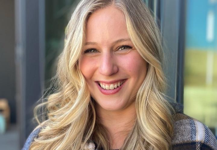 Blonde white woman smiling in flannel shirt