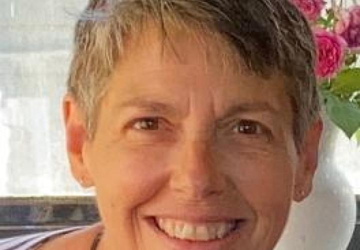 Photo of woman with short gray hair smiling at camera