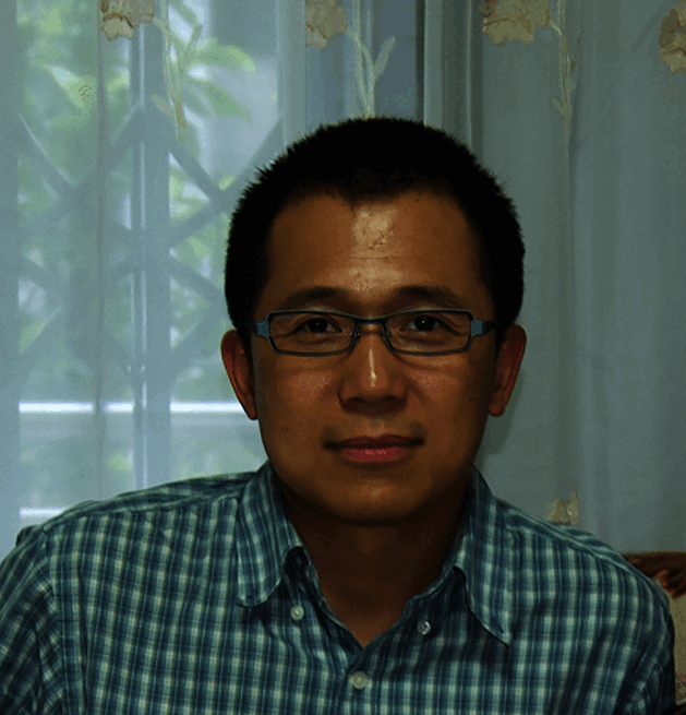Gang Lin, an asian man with short black hair and glasses looking at the camera. 