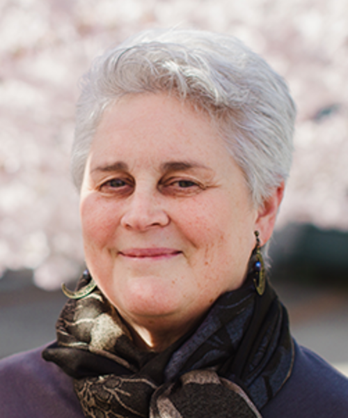 Gwen Shusterman, a white woman with short white hair smiling at the camera. 