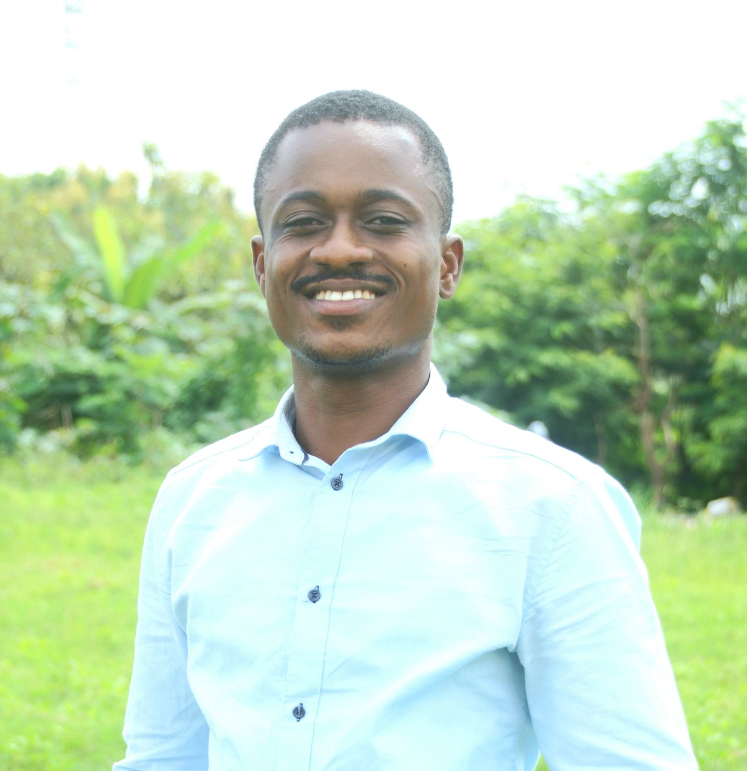 A professional photo of Emmanuel Frimpong, a black individual with short black hair and mustache.