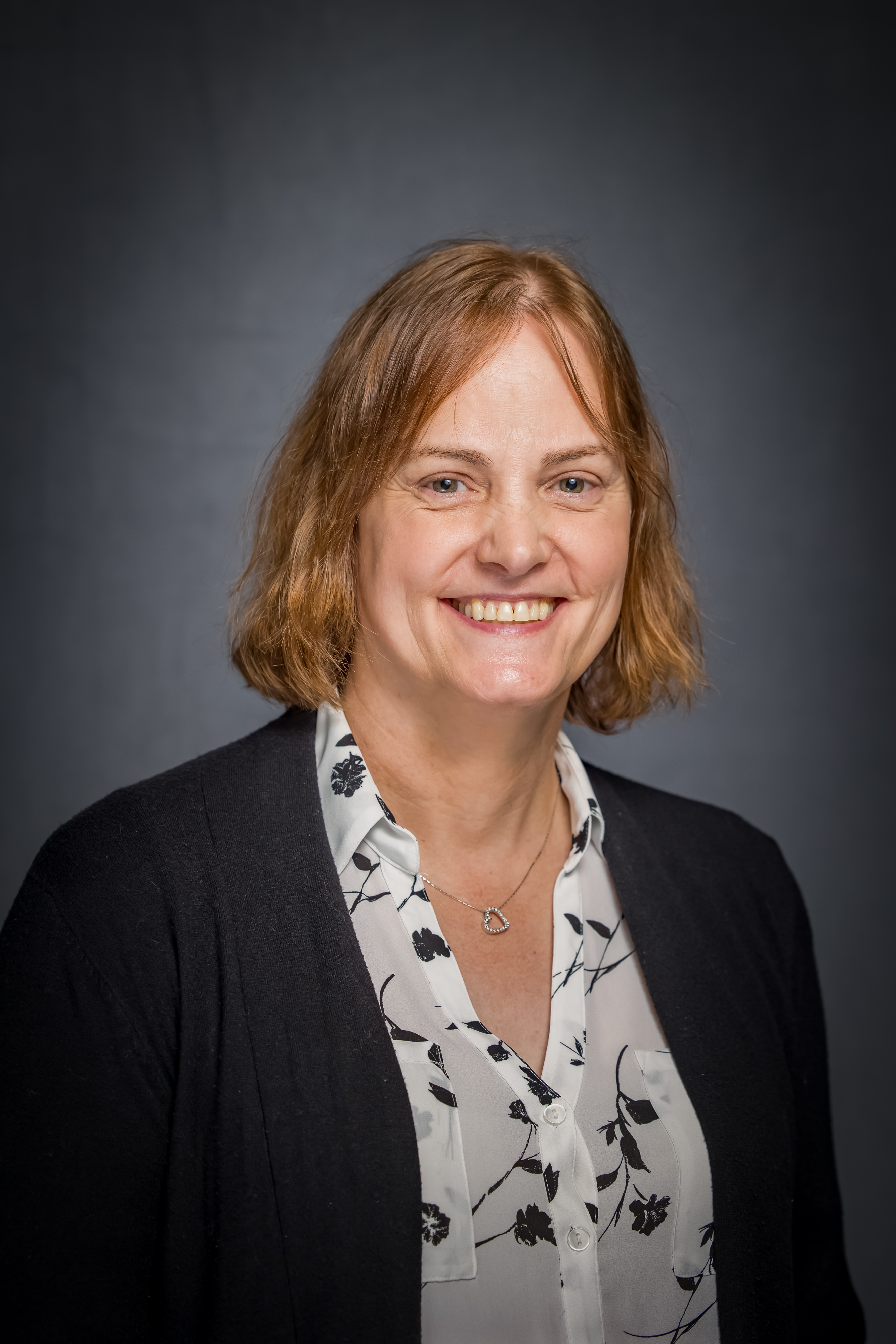 A photo of Robyn Tanguay, a white woman with red hair cut into a bob.