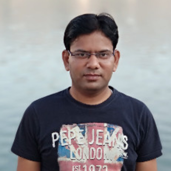 Amrendra, a light brown skinned man with short black hair and glasses, is wearing a black t-shirt with a Union Jack image on it.