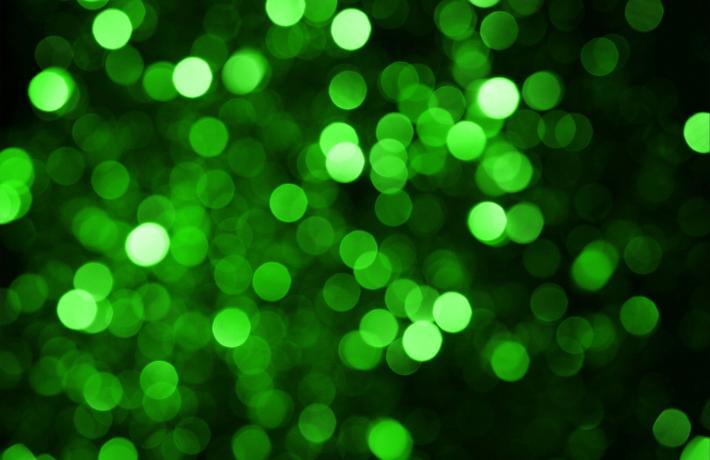 Green shiny circles on a black background.