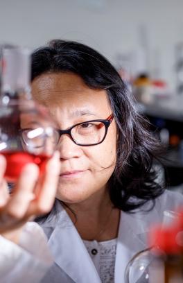 Scientist holds a flask. 