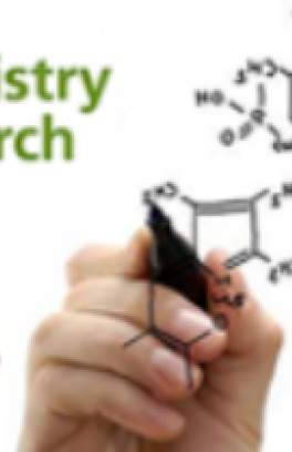 A placeholder image of a disembodied white hand sketching out a chemical formula on a clear surface facing the camera. 