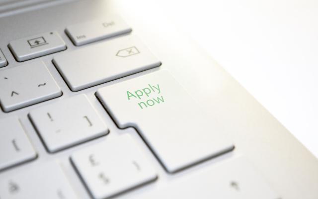 A close up of a keyboard with the text of the enter key replace with Apply Now. 