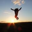 A outline of a person is seen jumping in front of a sunset.