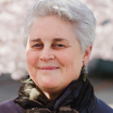 Gwen Shusterman, a white woman with short white hair smiling at the camera. 
