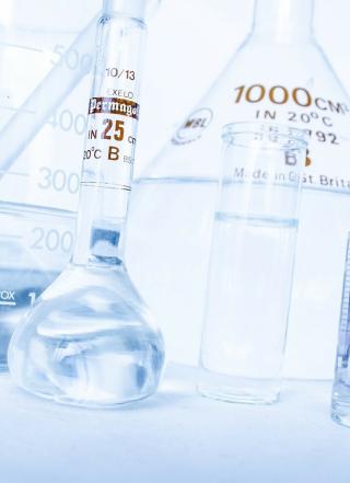 A closeup of a set of glassware with liquid inside on a table. 