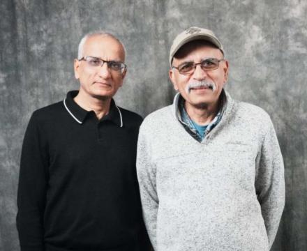 Portland State professors Suresh Singh, left, and Shankar Rananavare, right, are standing in front of a mottled grey backdrop.