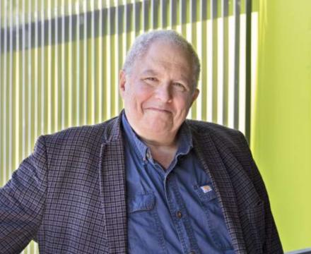 A professional portrait of Dr. Rob Strongin, an elder white gentleman with short white hair and wearing a suit jacket.