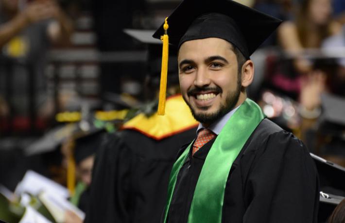 a graduating student, smiling
