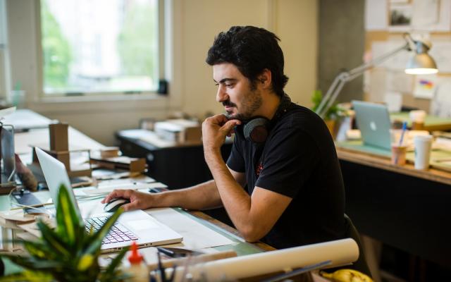 Student sitting at a desk using a laptop