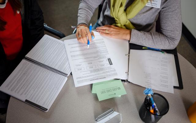 a table with advising forms scattered about