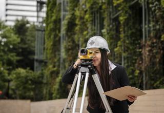 Engineering student using plane surveying equipment